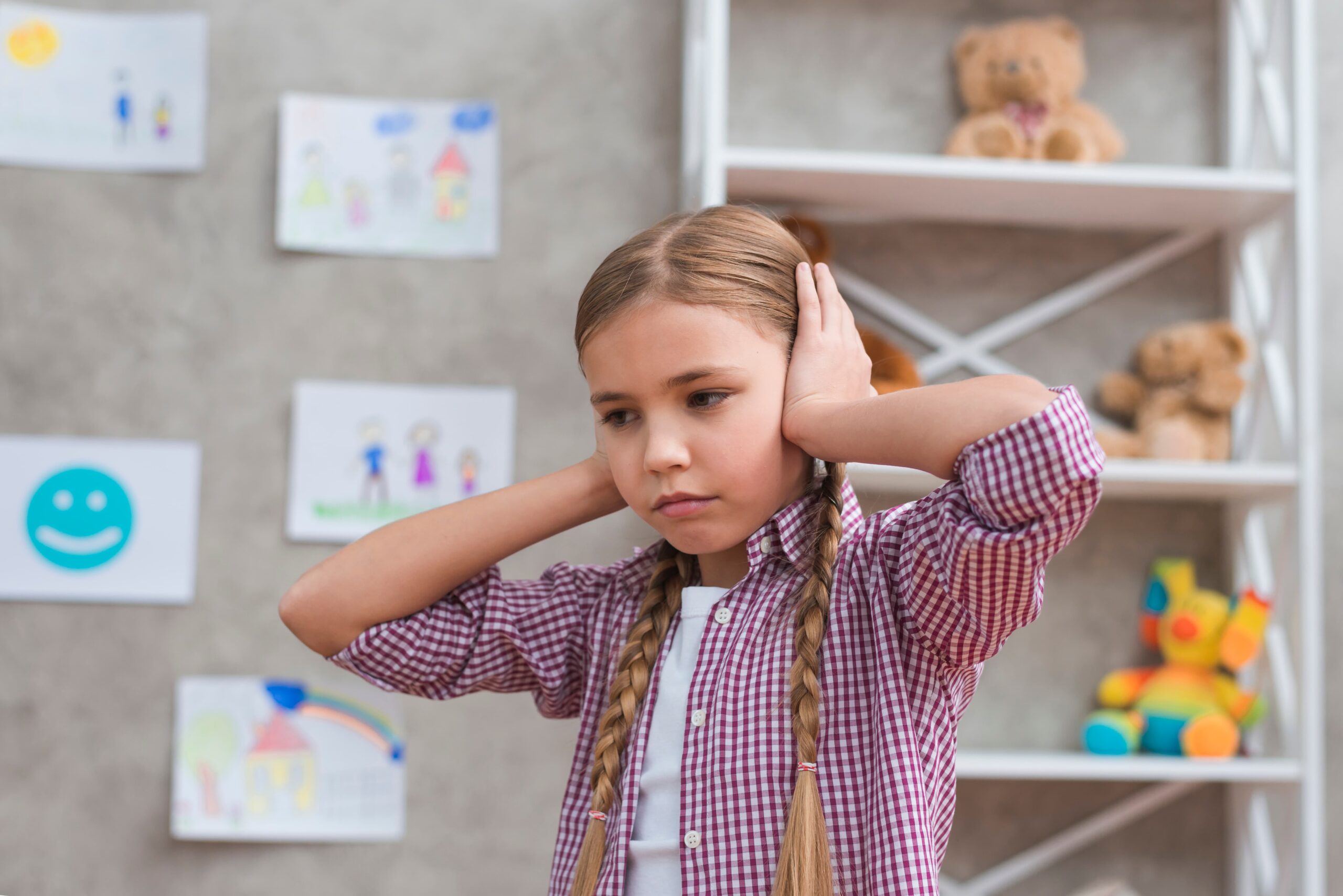 portrait sad girl covering her ears with two hands 1 scaled