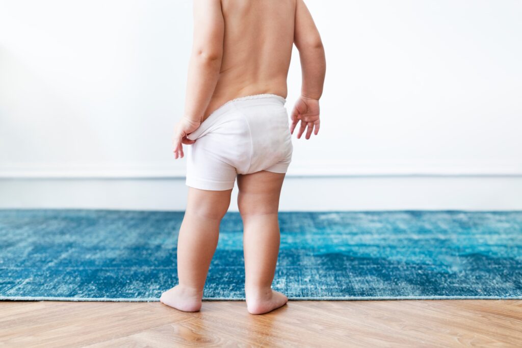 baby boy pulling his diapers 1