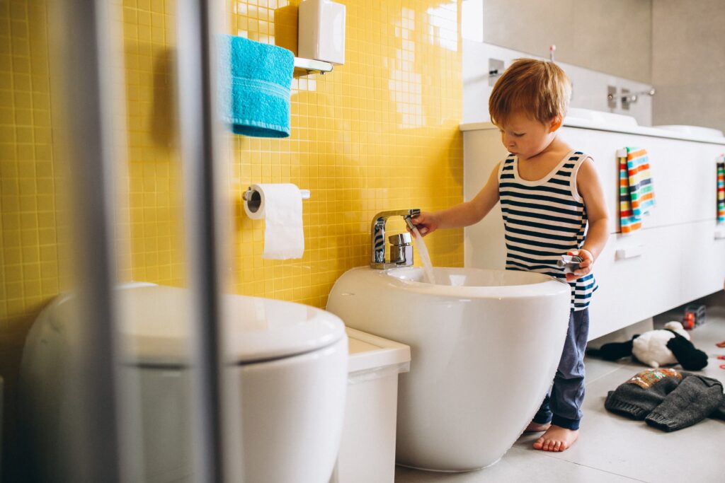 little boy fixing bathroom 1